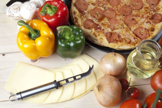 A couple of delicious pizzas, with raw tomatoes, green peppers and salami