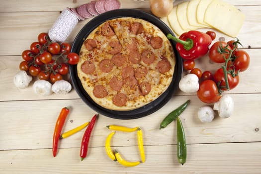 A couple of delicious pizzas, with raw tomatoes, green peppers and salami