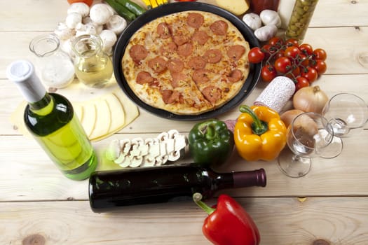 A couple of delicious pizzas, with raw tomatoes, green peppers and salami