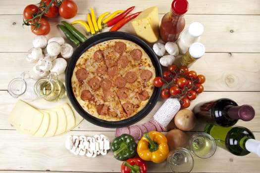 A couple of delicious pizzas, with raw tomatoes, green peppers and salami