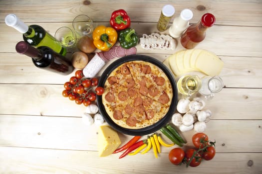 A couple of delicious pizzas, with raw tomatoes, green peppers and salami