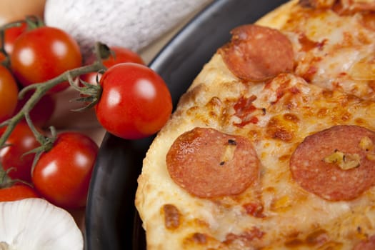 A couple of delicious pizzas, with raw tomatoes, green peppers and salami