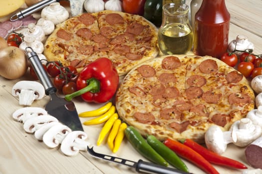 A couple of delicious pizzas, with raw tomatoes, green peppers and salami