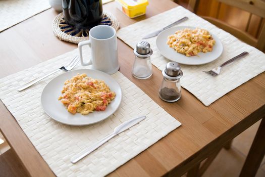 scrambled eggs on plates - delicious breakfast for a couple