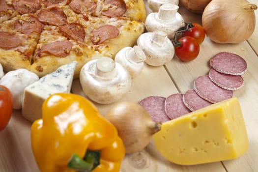 A couple of delicious pizzas, with raw tomatoes, green peppers and salami