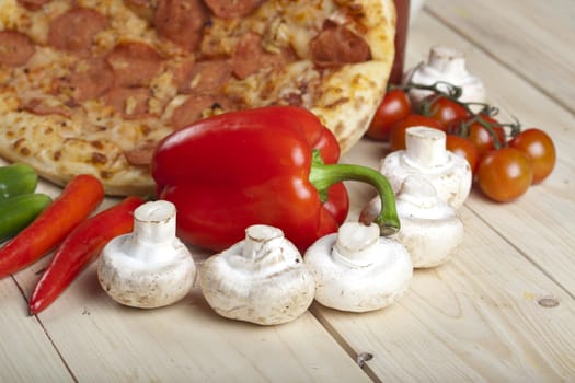 A couple of delicious pizzas, with raw tomatoes, green peppers and salami