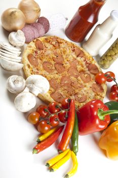 A couple of delicious pizzas, with raw tomatoes, green peppers and salami