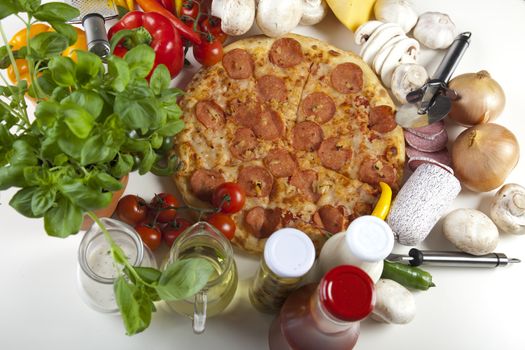 A couple of delicious pizzas, with raw tomatoes, green peppers and salami