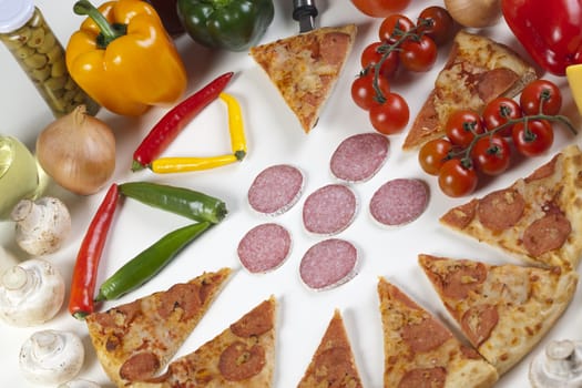 A couple of delicious pizzas, with raw tomatoes, green peppers and salami
