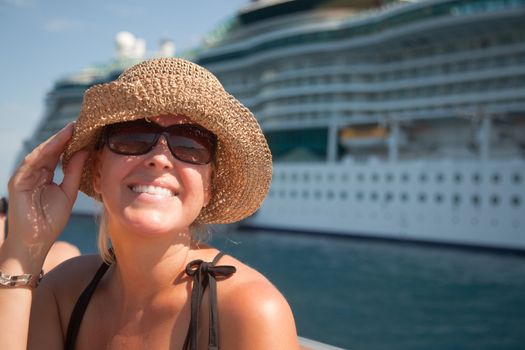 Beautiful Vacationing Woman on Tender Boat with Cruise Ship in the Background.