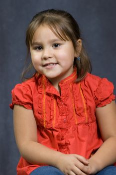 A four year old girl sitting getting her portrait done.