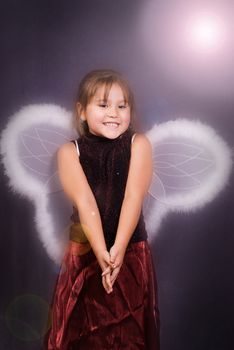 A young girl dressed in wings pretending to be an angerl