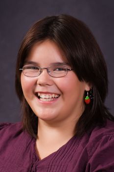 A 10 year old girl smiling for her school portrait