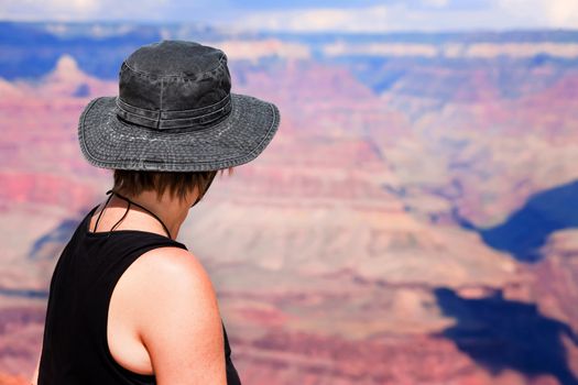 Female hiker looking over the ridge of the Grand Canyon