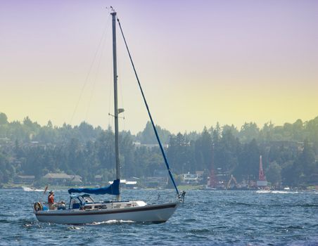 Sailboat without sails on Lake Washington viewed from Medina Beach.