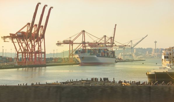 Port of Seattle and Space Needle during sunset.