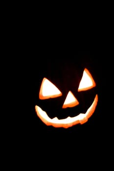 Halloween Smile Face Glowing through a Black Background