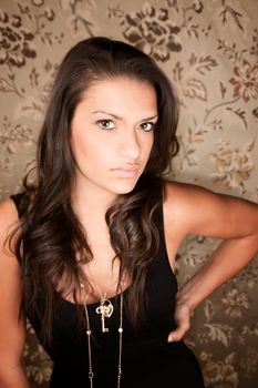 Portrait of beautiful brunette Hispanic woman in black dress