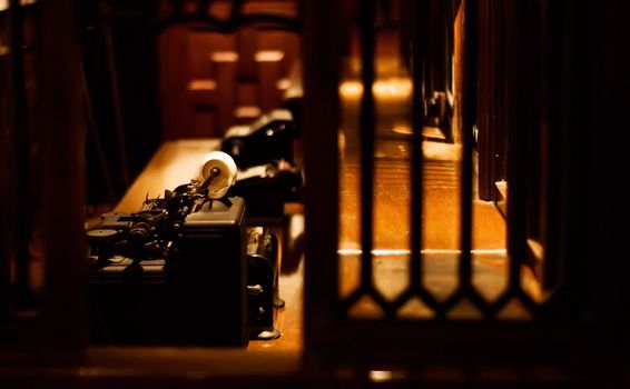 It is an old typewriter for bank on the desk.
