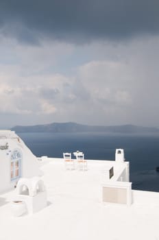 Two chairs on Santorini island, beautiful view, romantic