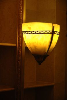a room decorative lamp casting light and shadows on a wall