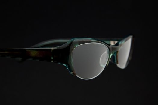 pair of green spectacles on dark background