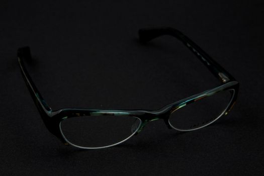 pair of green spectacles on dark background