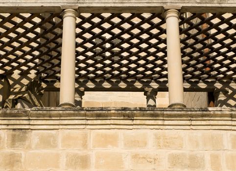 A medieval limestone balcony in traditional baroque style in Mdina on the island of Malta