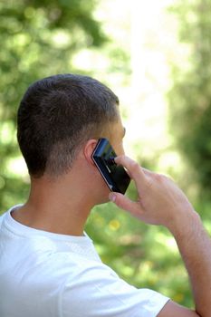 young man on the phone in forest