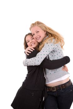 Two teenage girls hugging each other closely
