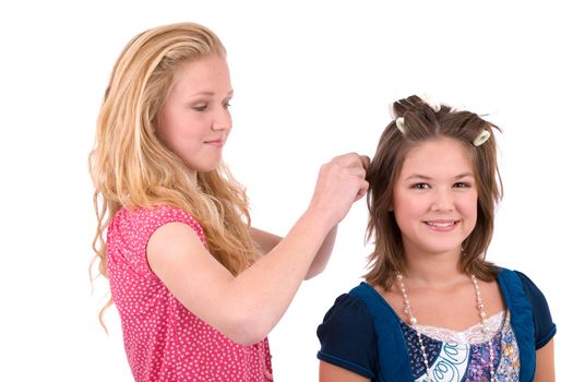 Two teenage friends doing each others hair