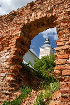 The old, partially destroyed church, kind on a dome through an aperture in a brick wall.