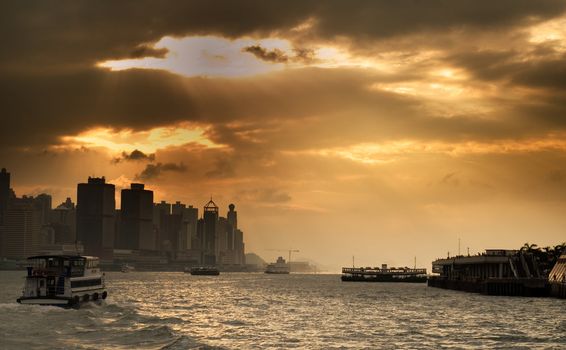 It is sunset cityscape of Victoria harbor in Hong Kong.