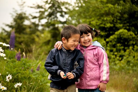 A boy and a girl holding each other and smiling