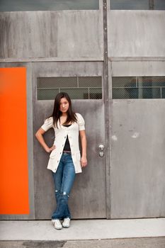 A teenage girl standing in front of a colorful background