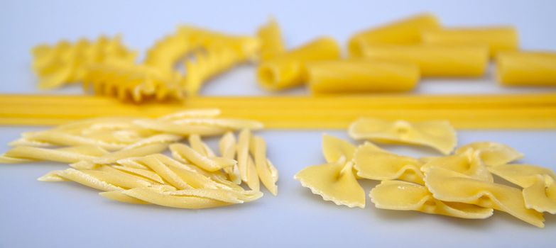 Five types of italian pasta over gray background