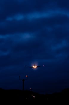 Airplane landing in the dark with the airport lights showing