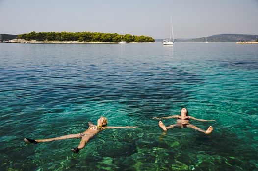 Two women relaxing on the Adriatic sea, Croatia.