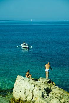 Woman and men on the beach of Adriatic sea, Croatia