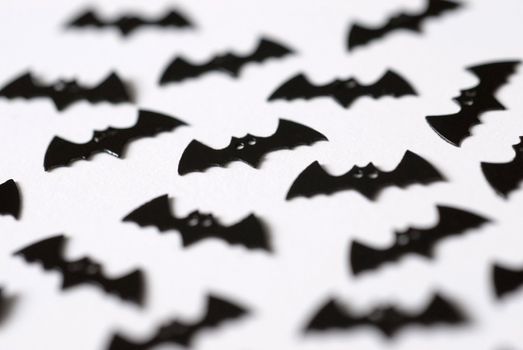 black plastic bat shaped halloween party decorations pictured with a narrow depth of field