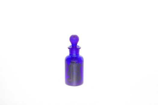 Isoalted Cobalt Blue Vial Bottle with Glass Stopper holding medicine. This type of vial is also used for perfume or essential oils for aroma therapy.