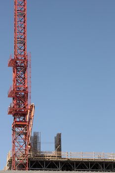 Red Construction Crane on roof of building.