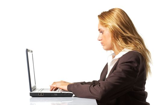 Profile view of a business woman working on a laptop over white