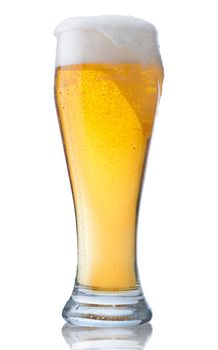 Fresh glass of pils beer with froth and condensed water pearls isolated on white background 
