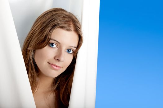Portrait of Fresh and Beautiful young woman over a blue background