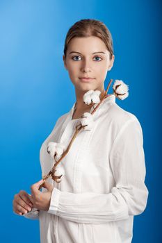 Portrait of a Fresh and Beautiful young woman holding a cotton plant