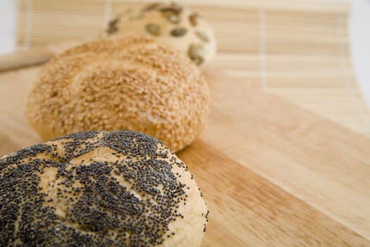 tasty and crispy fresh 3 rolls on wooden background