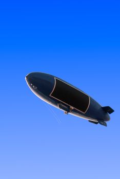 dirigible airship zeppelin over clean blue sky background