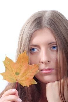 Portrait of the thoughtful nice girl with maple autumn sheet