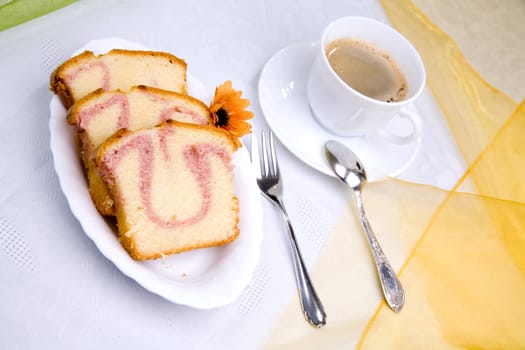 sweet cake on dish with flower and coffee